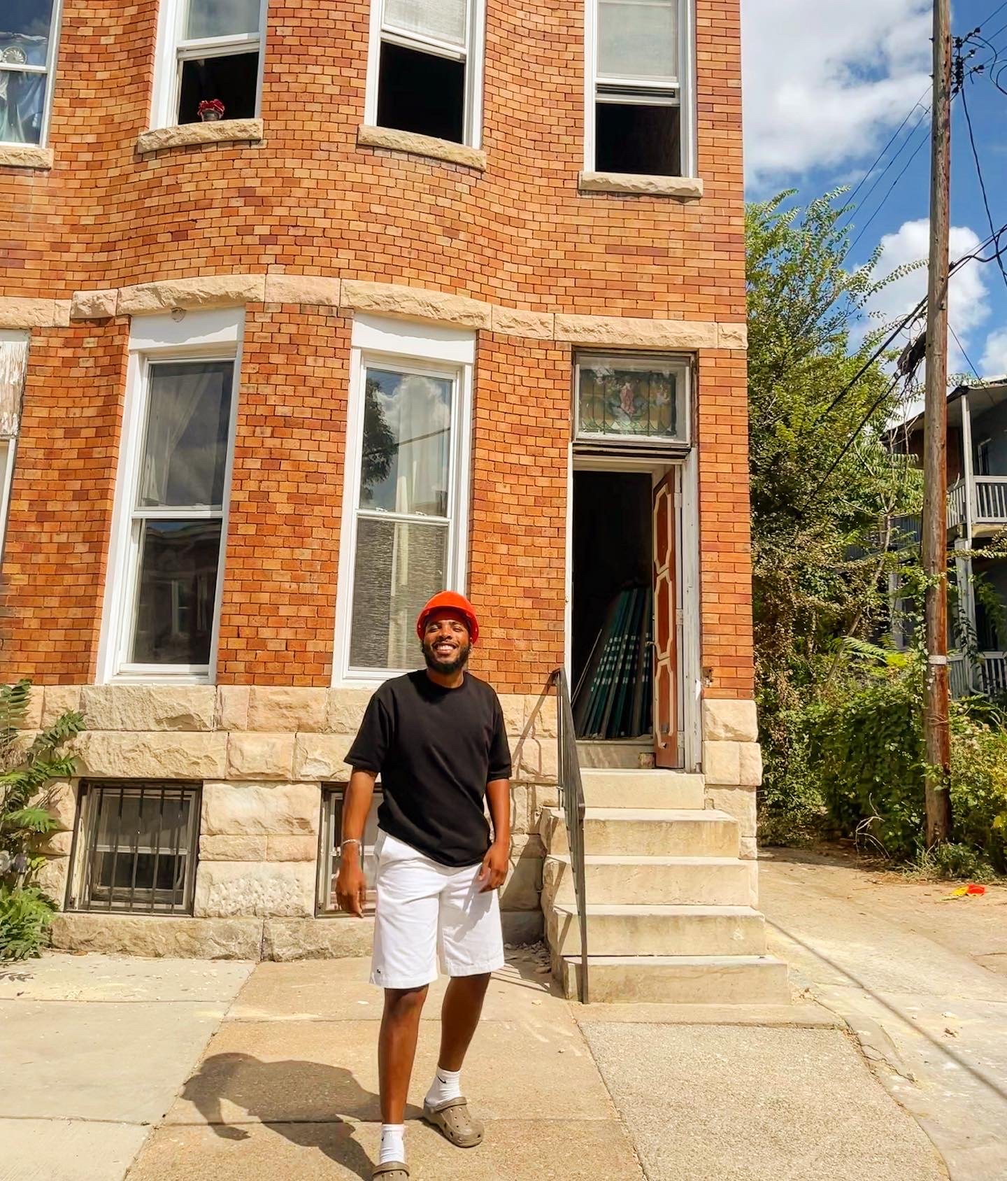 Bryon standing outside a brick building