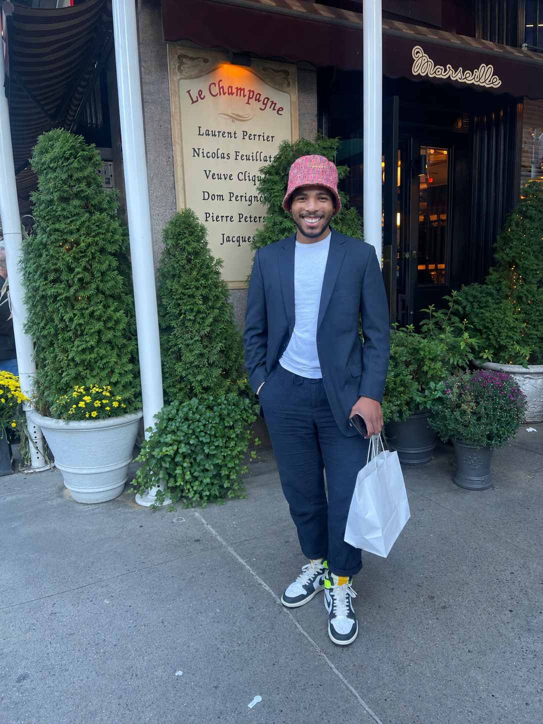 Bryon Lewis-Cummings in a suit outside a city restaurant